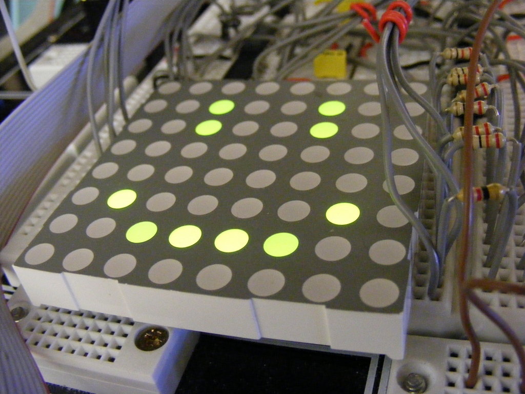 8x8 LED dot matrix display showing a smiley face.